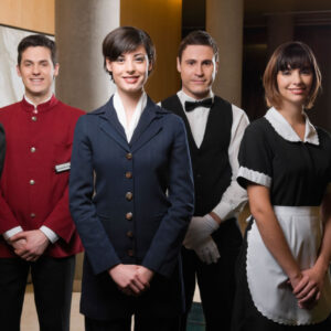 B62PW9 Hotel staff standing together and smiling